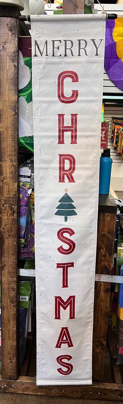Merry Christmas vertical banner. White, with red lettering and green Christmas tree. 6-feet by 1 foot