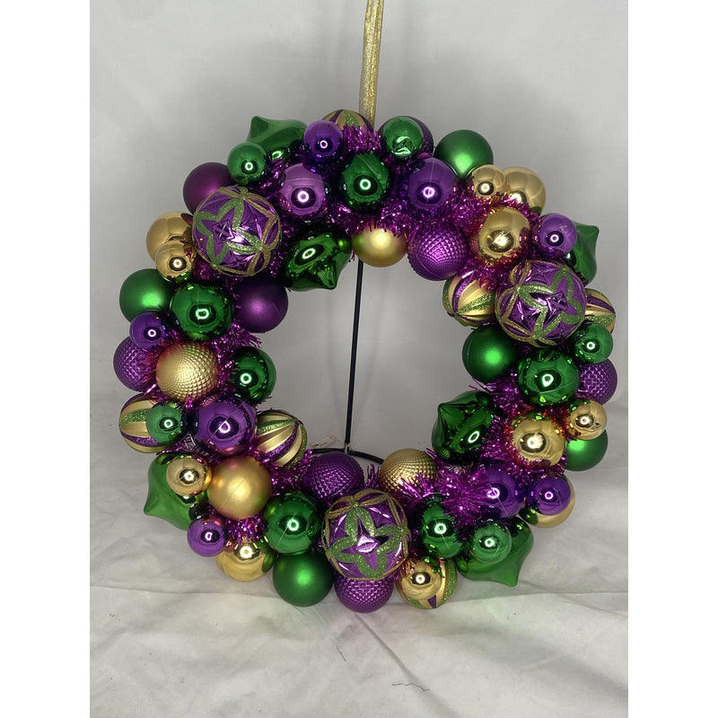 Colorful Mardi Gras wreath made of purple, gold, and green ball ornaments